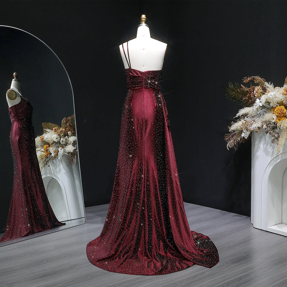 Backless detail on one-shoulder satin prom gown with sweep train