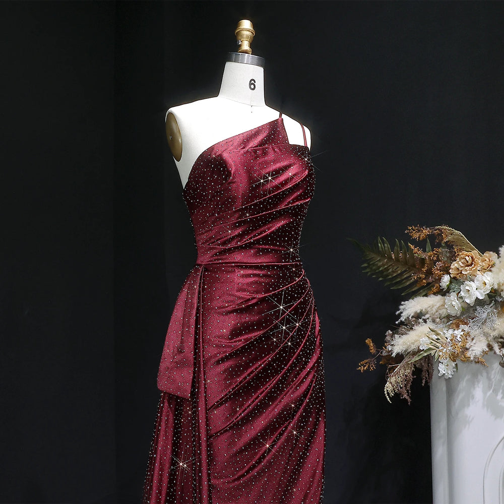 Close-up of one-shoulder satin bodice with draped waist detailing