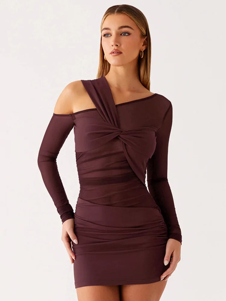 Woman wearing a wine colored off-shoulder dress on a white background