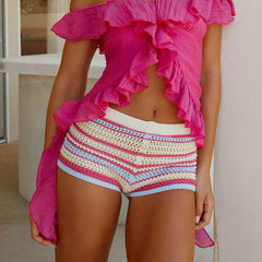 A full-length shot of women's casual striped shorts styled for a day at the beach.