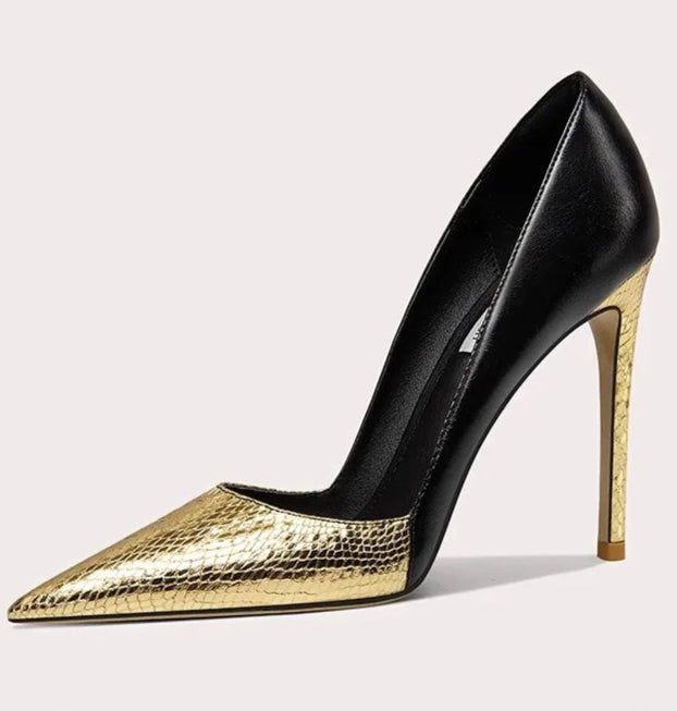 Black and gold high-heeled shoe on a light gray background