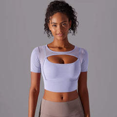 Woman wearing a  slim fit mesh workout tee shown for fitness and athleisure on a grey background