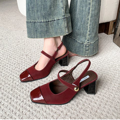 Close-up of glossy wine red block heel sandals with buckle strap