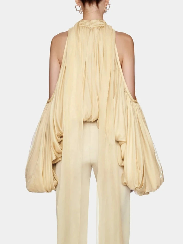 A back view of a woman's slim-fit crop top, highlighting the halter neckline.