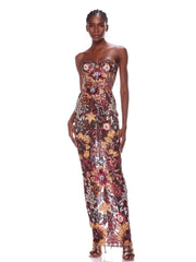 A woman wearing a formal, strapless, floral sequin, backless, long runway gown dress.