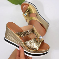 Side angle of patent leather super high wedge sandals in gold