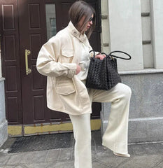 The structured silhouette of the short coat, showing its elegant fit.