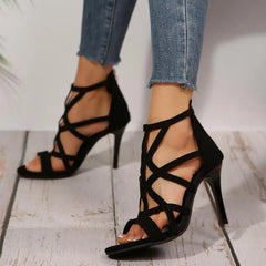 Side angle of suede-inspired black cross strap high heel sandals