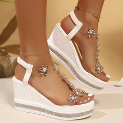 White PVC wedge sandals with shimmering crystal flower accents