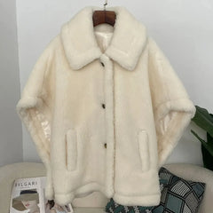 Soft wool teddy coat hanging on a wooden hanger, showing the relaxed shape and button-front design