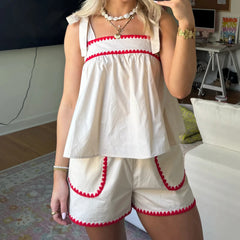 A woman modeling a Y2K-inspired floral shorts set with a peplum cami top.