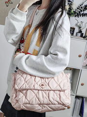 Soft padded pink tote with floral emblem and quilting