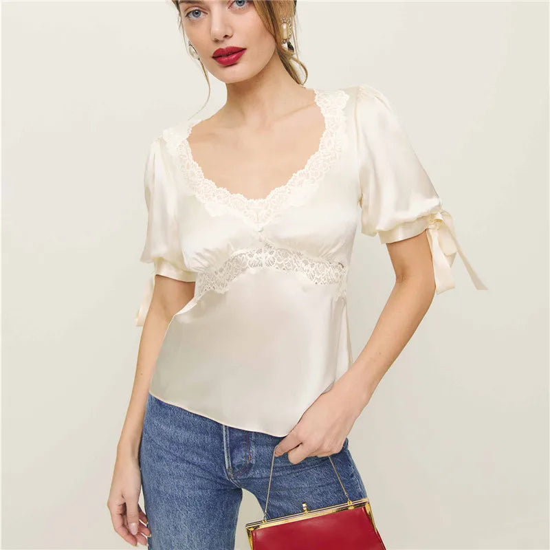 Lace patchwork blouse shown with adjustable ribbon tie