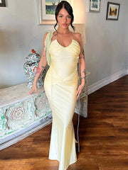 Yellow halter backless maxi dress with ruched detailing for evening wear