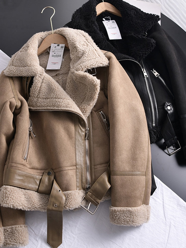 Two women's coats, one in beige and the other in black, both with fur lining and zipper details, were displayed on hangers.