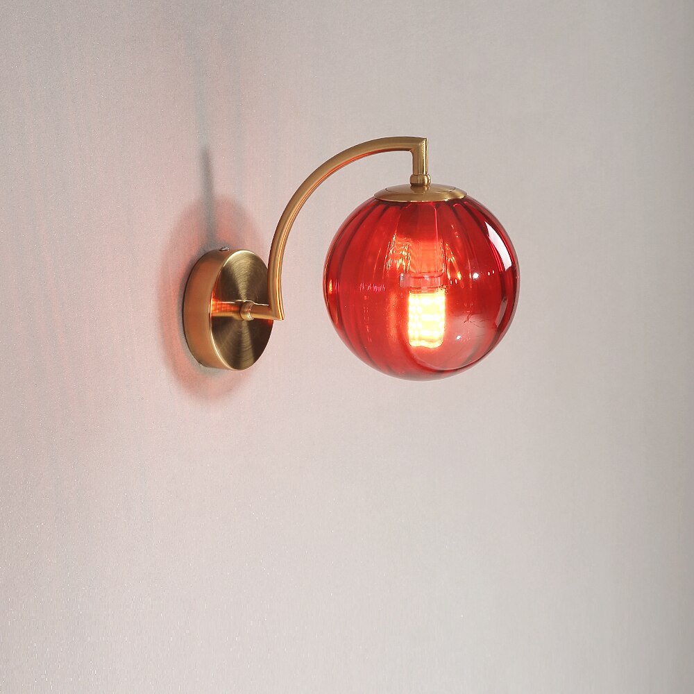 A modern red LED colour glass pendant light fixture mounted on a wall.
