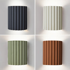 Several LED resin wall lights in various colors (gray, green, orange, white) displayed against a white background, showing the shade's direction and the LED bulbs within.