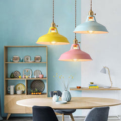 A collection of colorful hanging ceiling lampshades in various vibrant colors, including yellow, blue and pink, against a neutral background with decorative items  over a dining table.
